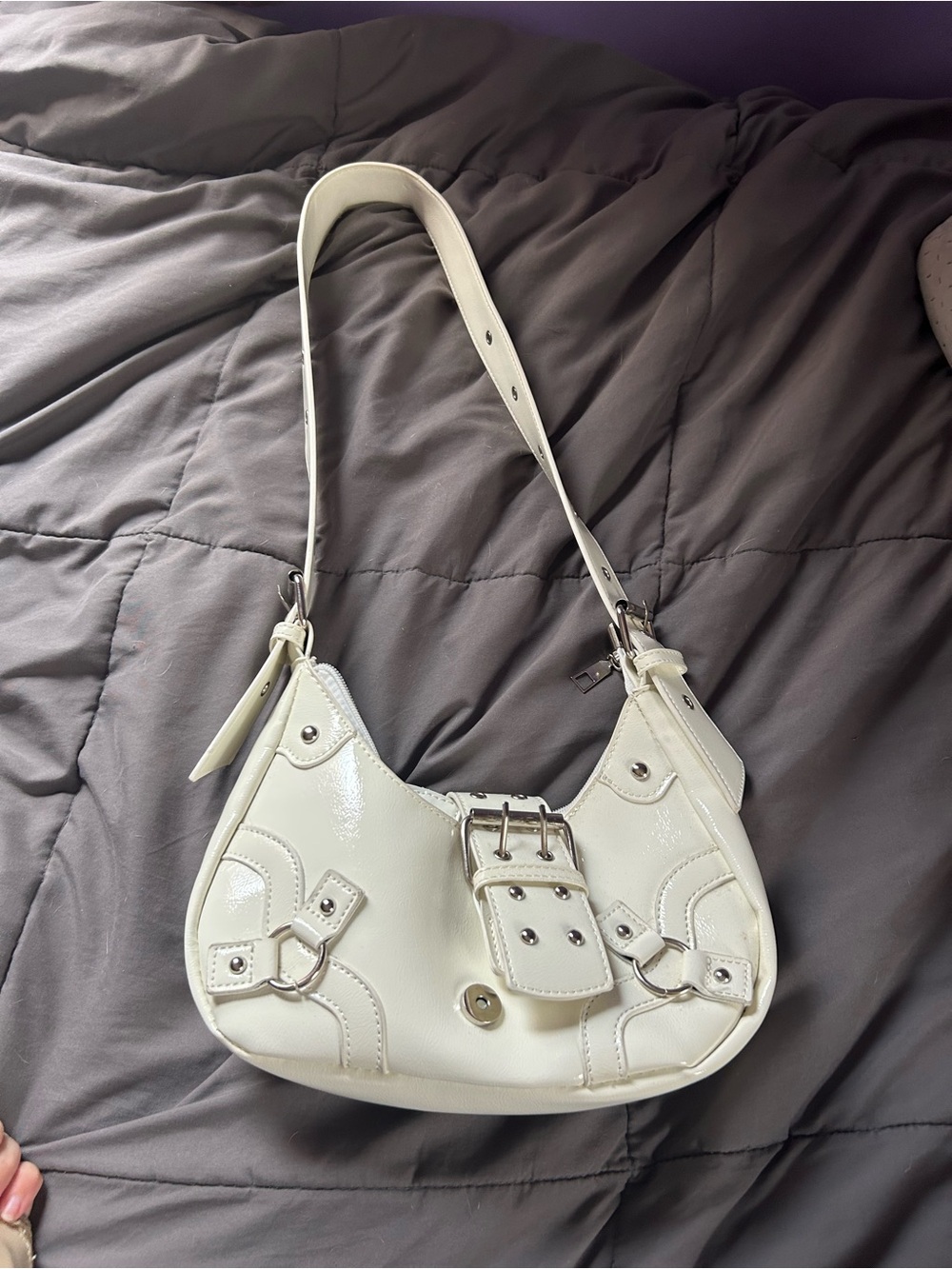 White leather crossbody bag with buckle detail and adjustable strap